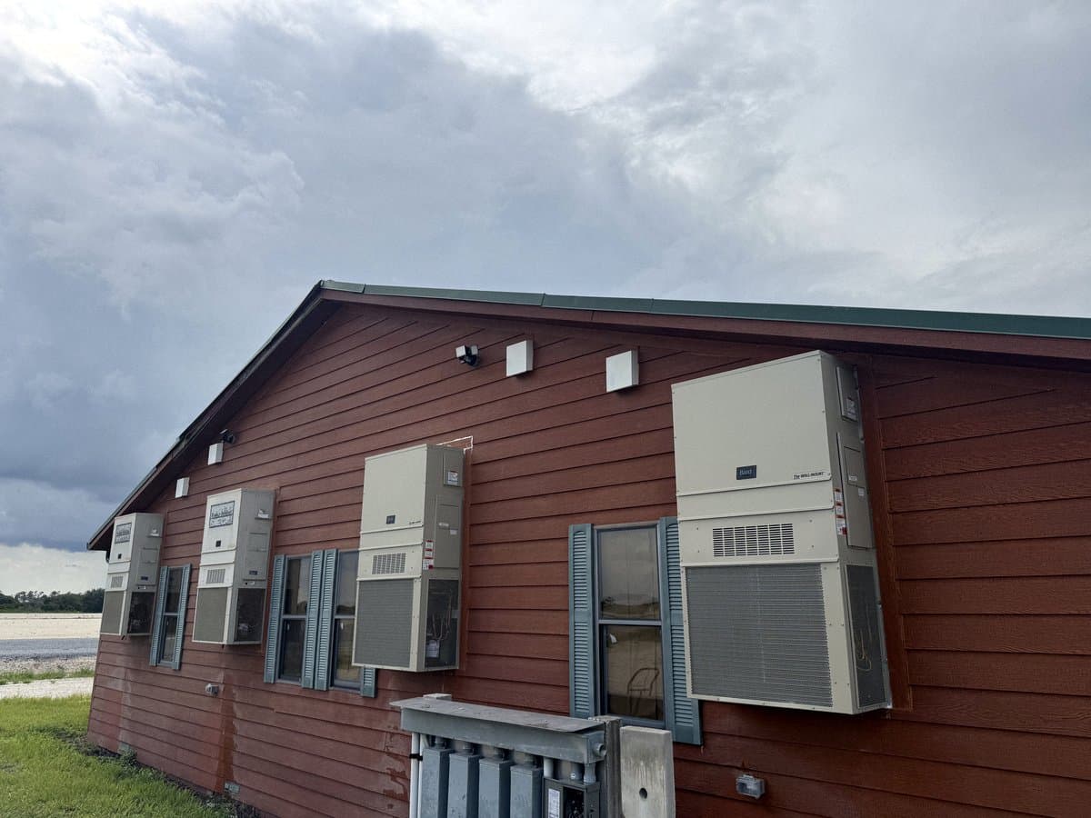 Wall-mounted package units along the side of a commercial building